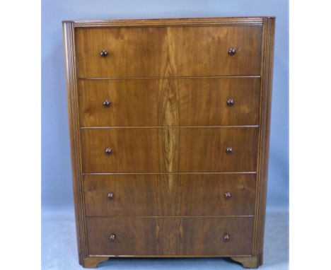 A mid century walnut chest of five drawers, raised on bracket feet, with label for Austinsuite, H.110 W.85 D.46cm 