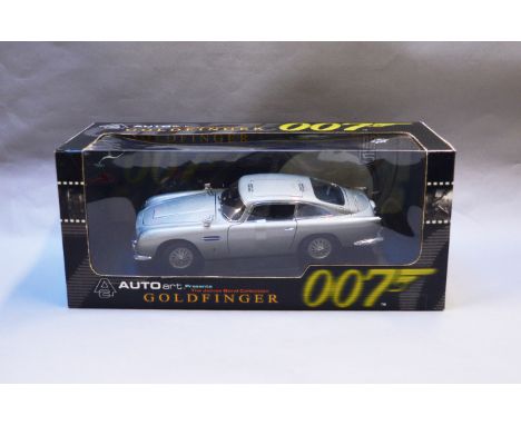 James Bond 007. A boxed Autoart 1:18 scale Aston Martin DB5 version with Gadjets and Roof Panel, issued in 1999, modelled on 