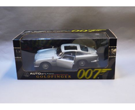 James Bond 007. A boxed Autoart 1:18 scale Aston Martin DB5 version with Gadjets and no Roof Panel, issued in 1999, modelled 