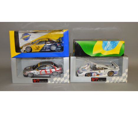 3 boxed UT Models diecast car models in 1:18 scale including an Opel Calibra V6, a Porsche 911 GTI and an Audi A4 STW (rear s