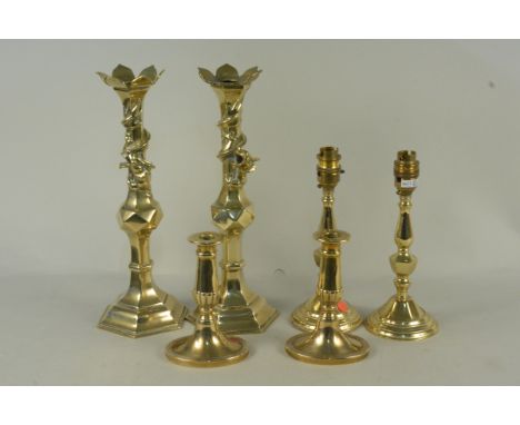 Two pairs of brass candlesticks, one pair with dragons coiled around the top, 33cm tall (one as found) plus a pair of brass t