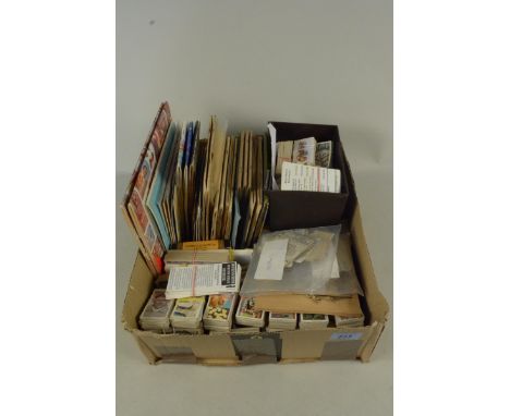 A selection of cigarette card albums, loose and banded sets, twelve empty cigarette packets, tea cards, business cards etc