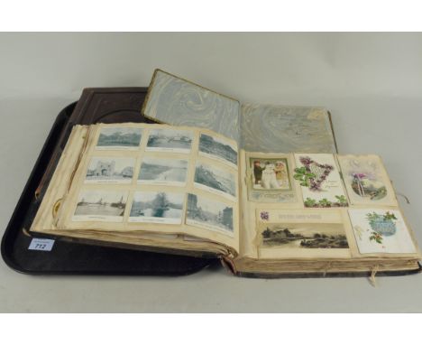 A Victorian photograph album half filled with period photos, a Victorian scrapbook well filled with greeting cards, cigarette