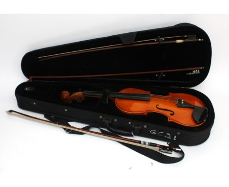 A Stagg full size violin, with a chin rest and three bows, one being a Golden Strad, in fitted case.