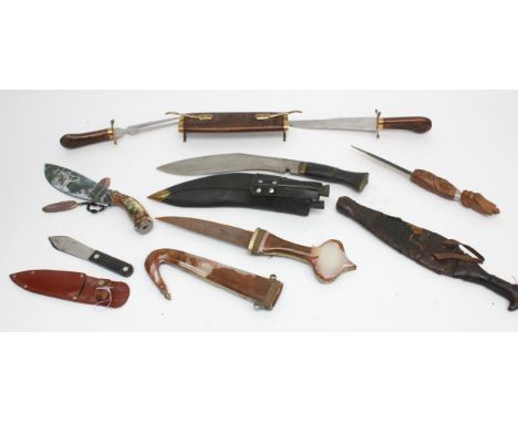 A collection of seven 20th century and later reproduction daggers to include Jambiya, decorative hunting knives and kukri.