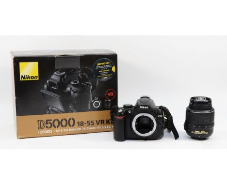 A Nikon D5000 digital camera, with a Nikon f/3.5-5.6 18-55mm lens, boxed.