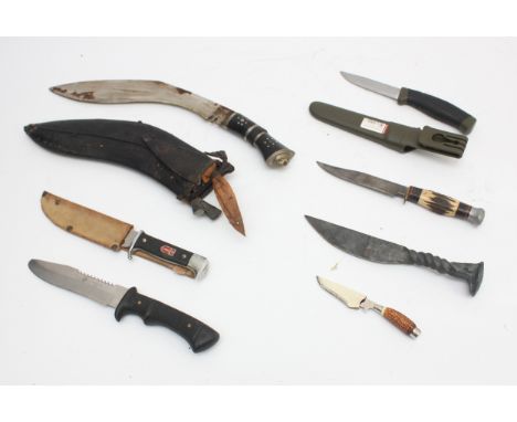 A collection of seven 20th century and later reproduction daggers to include an Indian kukri, Aloe hunting knife and others, 