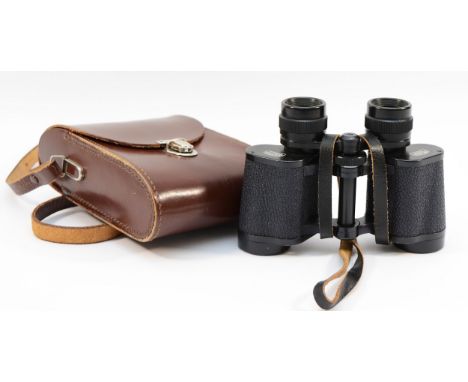 A pair of Carl Zeiss Jenoptem binoculars, 8 x 30, with leather case.