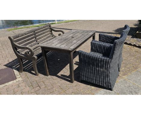 A hardwood garden table, 140 x 70cm, a matching hardwood bench and two Kettler rattan armchairs (4).