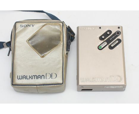 A Sony Walkman WM-DD cassette player, with crossbody travel bag.Untested.Cosmetically in good condition showing only light sc