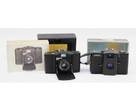 Two small film cameras, a Minox 35 GT and a Lomo Minitar 1. (2)