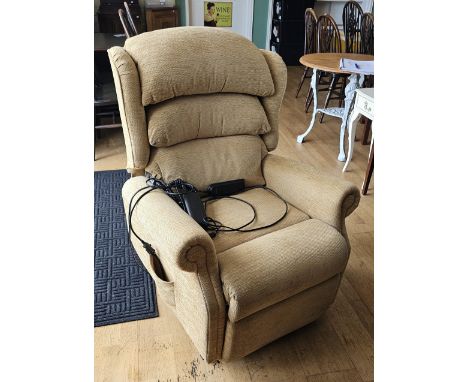 A Celebrity electric rise and fall armchair, in beige fabric, working order