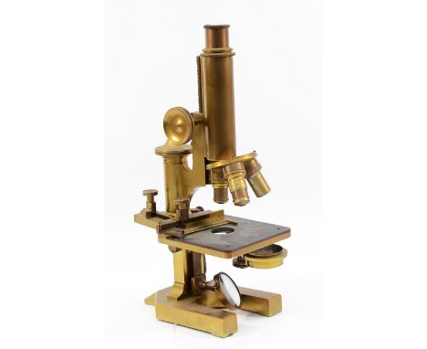 A brass microscope, stamped 'R &amp; J Beck. London. 22838', with a Carl Zeiss Jena 18mm lens, H-32cm.