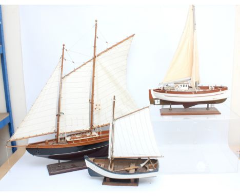 Three scratch built model ships, to include, a gaff-rigged yacht, 84cm x 85, a fishing boat, 48 x 42, and a sailboat in Persp