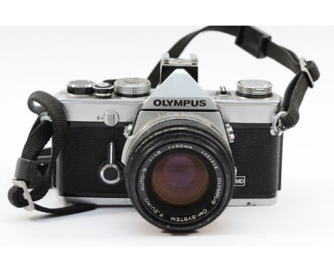 An Olympus OM-1N film camera with an Olympus Zuiko f/1.8 50mm lens. 