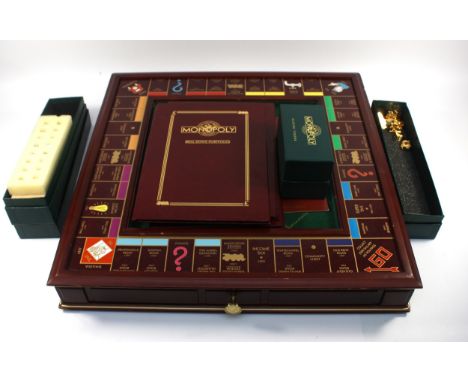 Franklin Mint; A 'Collectors Edition' Monopoly set by Franklin Mint, the hardwood framed felt playing board with fitted drawe