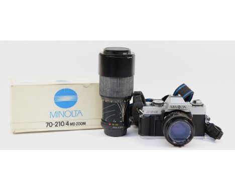 A Minolta XG-M film camera with a Minolta f/1.7 50mm lens, and a Minolta f/4 70-210mm lens, boxed.