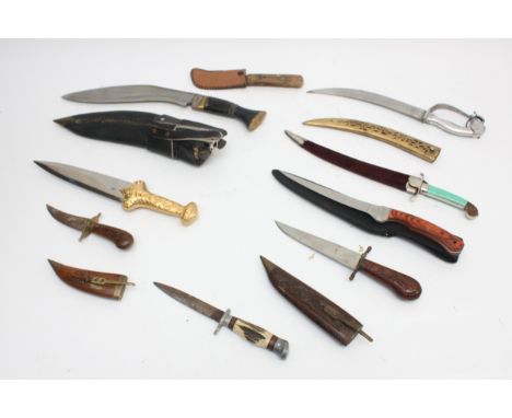 A collection of eight 20th century and later reproduction daggers to include Jambiya, Kukri and Indian, largest blade 27cm.