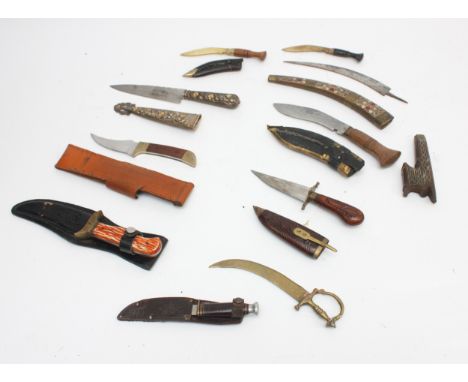 A collection of ten 20th century and later reproduction daggers to include Jambiya, hunting knives and a miniature kukri.