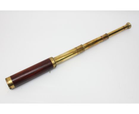 A late 19th Century brass three draw Naval officers telescope, by Dolland London In England 1885, marked with the broad arrow