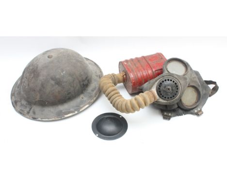 WWII British MKII steel helmet, unmarked, together with a gas mask, patented 296.4938 and 305.080, complete with cannister an