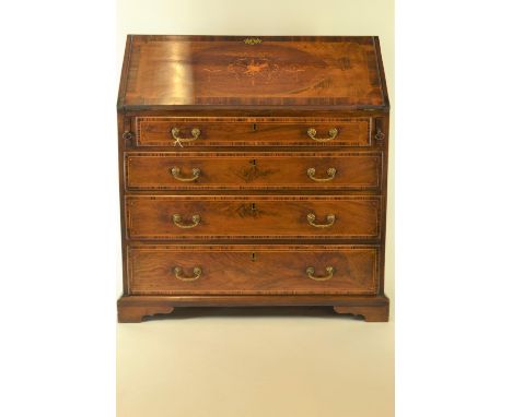 An Edwardian inlaid mahogany writing bureau, with fall front revealing fitted interior, above 1 short and 3 long crossbanded 
