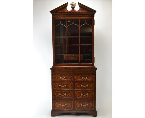 Theodore Alexander mahogany library bookcase, with a broken architectural pediment centered by the Spencer arms, above a blin