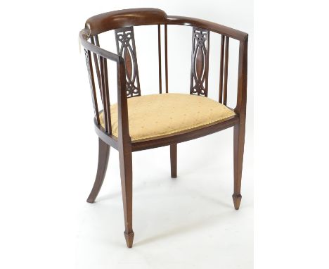 An Edwardian mahogany tub chair, with inlay detail & arrow supports. W54cm d44cm h76cm 