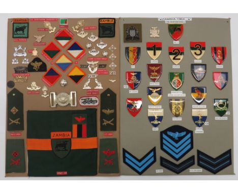 Zambia - 63 Items Of Insigniatwo display boards with good tabulated display of metal and cloth badges including anodised Zamb