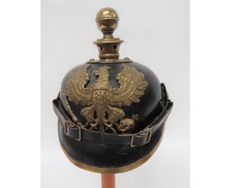 Imperial German Prussian Artillery Pickelhaube black leather crown, attached peak with brass edging.  Attached rear brim with