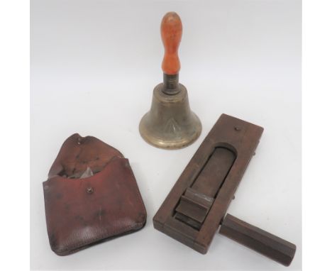Small Selection of Equipment Including Home Frontincluding a wooden hand rattle with steel backing panel ... Brass handbell, 