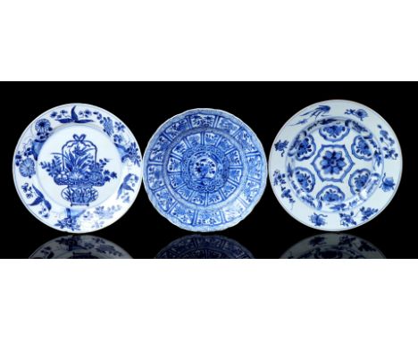 3 porcelain dishes with different blue decorations, including one with a flower basket and one with Buddhist symbols, includi