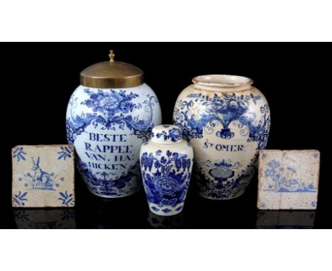 2 Delft blue earthenware tobacco jars including the inscription St Omer and Beste Rapee Van Ha Hicken (1 with copper lid, 1 w