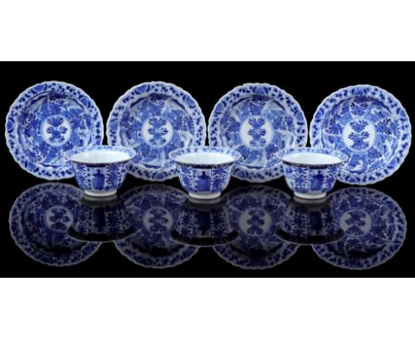 3 contoured cups and 4 saucers with blue floral decoration, marked, China 19th century (1 cup with 2 chips, saucers with chip