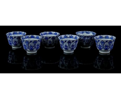 6 contoured porcelain cups with blue floral decoration and butterflies, Kangxi marked, China 19th century, 6 cm high, 9 cm di