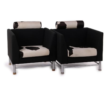 Ettore Sottsass (1917-2007)2 Postmodernism black upholstered armchairs with seat and headrest covered with cowhide, standing 