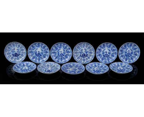 11 contoured porcelain dishes with blue floral decoration and butterfly at rock, Kangxi marked, China 19th century, 15 cm dia