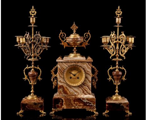 Marble clock with copper mounting, vase on top and standing on claw feet, movement marked AD Mougin, 47 cm high, 25 cm wide a