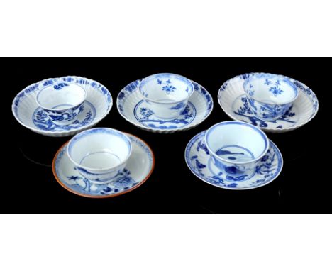 3 contoured porcelain dishes with blue floral decoration near a rock, marked including yin-yang symbol, China Kangxi period c