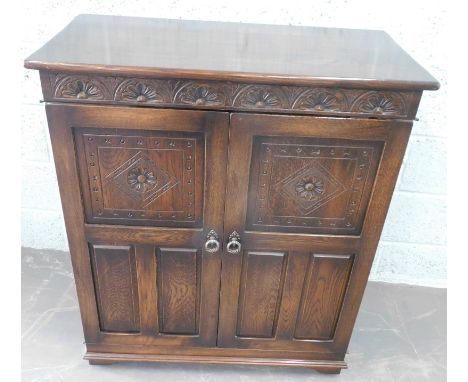 An Old Charm style small cupboard, with two panelled doors, on bracket feet, 90cm wide