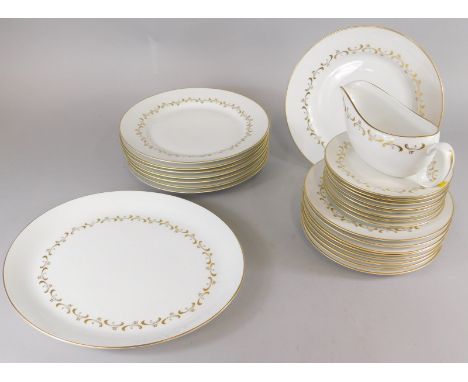 A Royal Worcester Verona pattern part dinner service, decorated in gilt with scrolls.
