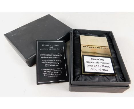 A Benson and Hedges limited edition gold plated cigarette case, modelled in the form of a cigarette packet, sold with certifi