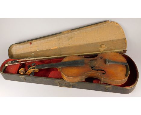 A late 19th/early 20thC violin,  with two piece back, Stradivarius label, length of back 35.5cm and a bow with bone finial, e