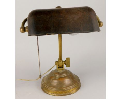 An early 20thC brass adjustable desk lamp, with bronzed shade, beaded on/off pull and iron filled tapering domed foot, 39cm h