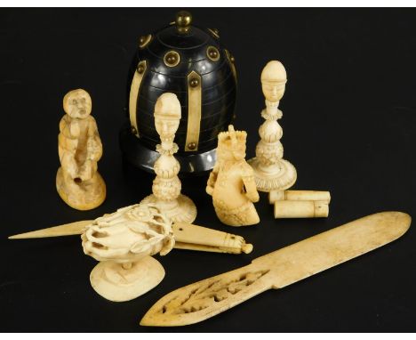 A collection of ivory and bone etc., to include chess pieces, a crude carving of a boy, possibly netsuke, a bone copy of a pe