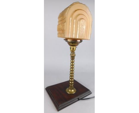 An Art Deco style brass table lamp, with part frosted glass shade and later mahogany plinth, 48cm high overall