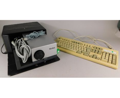 A slide projector, with carousel and an Acorn computer keyboard