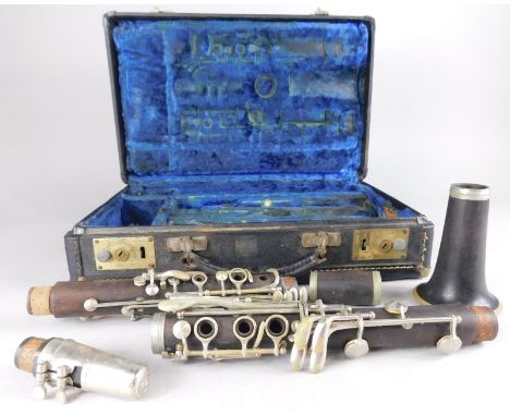 An early 20thC composition clarinet, indistinctly marked in a fitted case