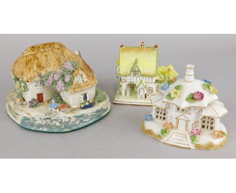 A ceramic fisherman's cottage by Jane King,  two Coalport cottages and bird ornaments