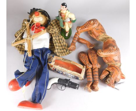 A collection of toys, to include a Balinese type tiger, an outlaw pepper box for short pistol, a clown puppet etc